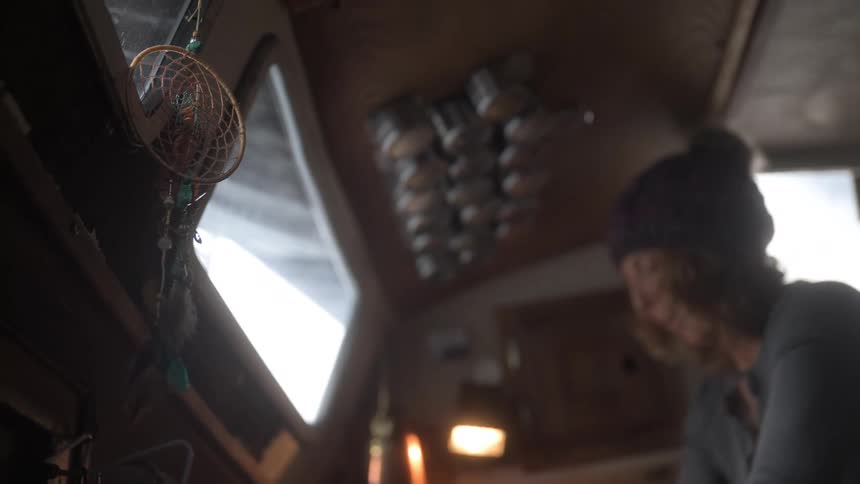 Woman cooking inside a boat