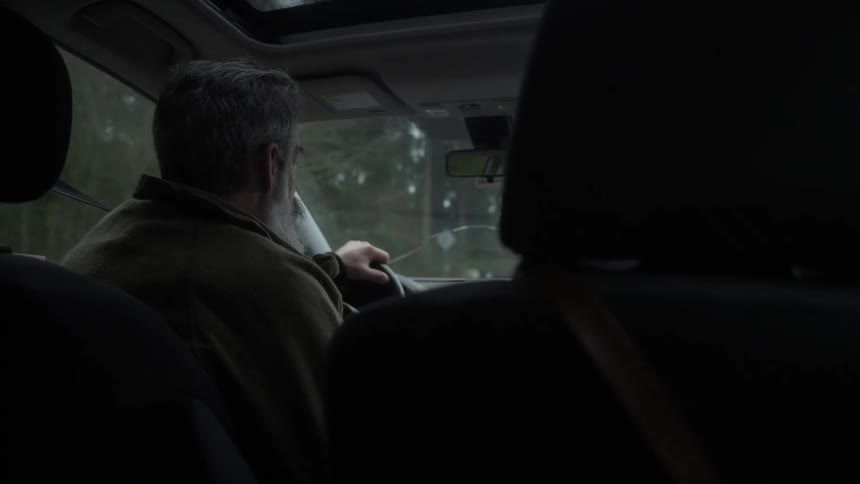 A close up clip of a man driving