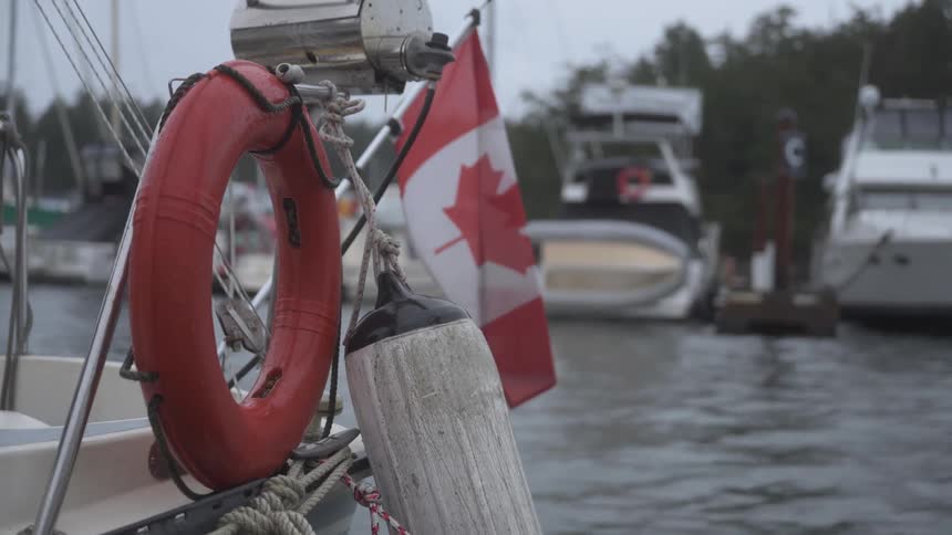 Waves in the water make a boat bob up and down and moves the flag