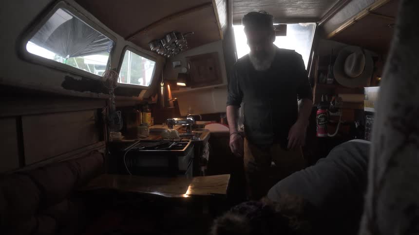 Woman and a man organizing the kitchen of a boat