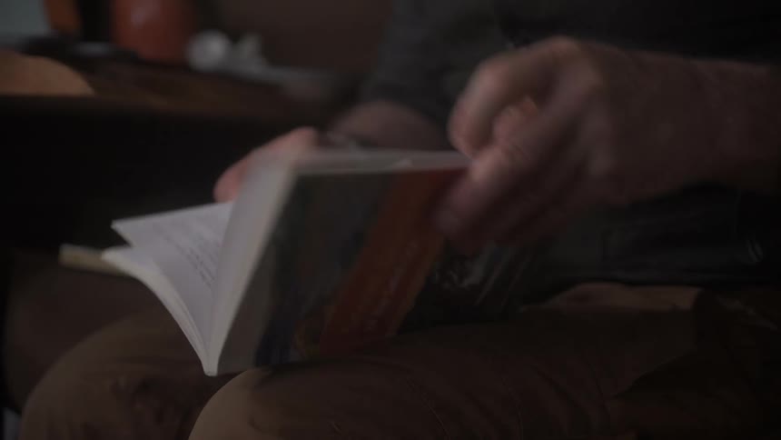 Hands leafing through a book