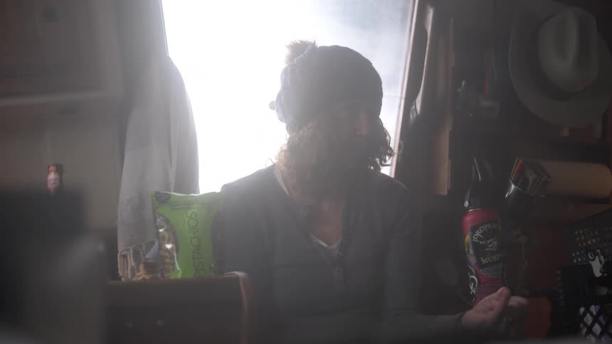 A woman is talking with someone by the window
