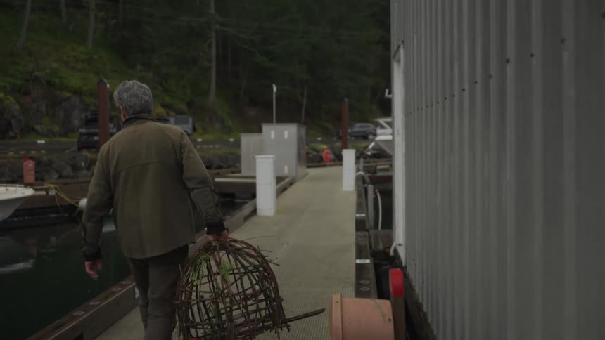 A footage of a person carrying a fish cage