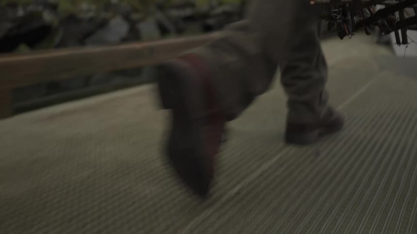 Person walking carrying fishing trap