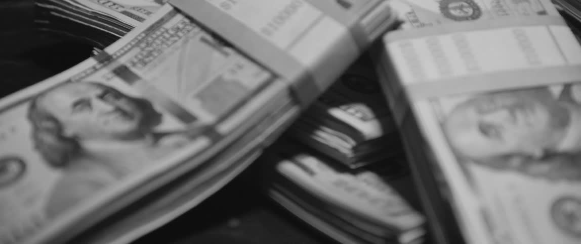 Close up of hundred dollar bills bundled together