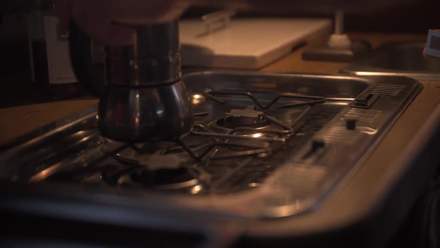 Person with a match lighting a stove fire