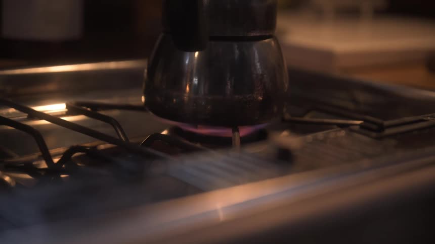 A pot is cooking on the stove top