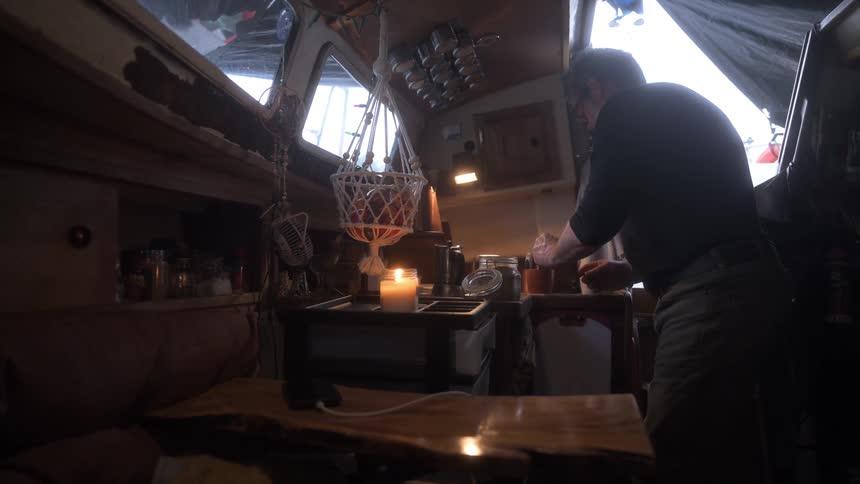 A man is cooking on the boat