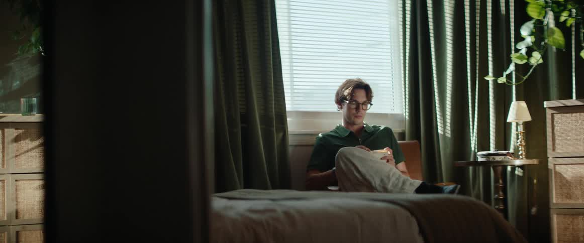 Man sitting in a room reading a book