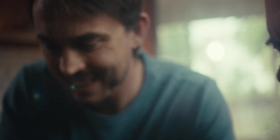 Young man and an elderly man looking forward happily