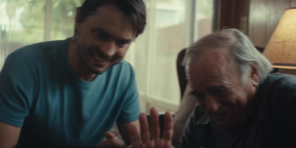 Two men wave while on a video call