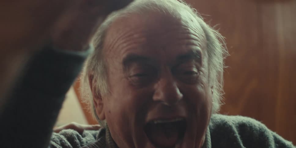 A man yells and cheers at the laptop