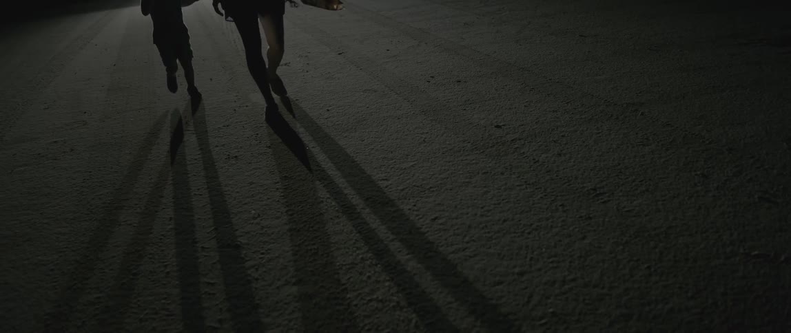 People walking cast shadows onto the ground
