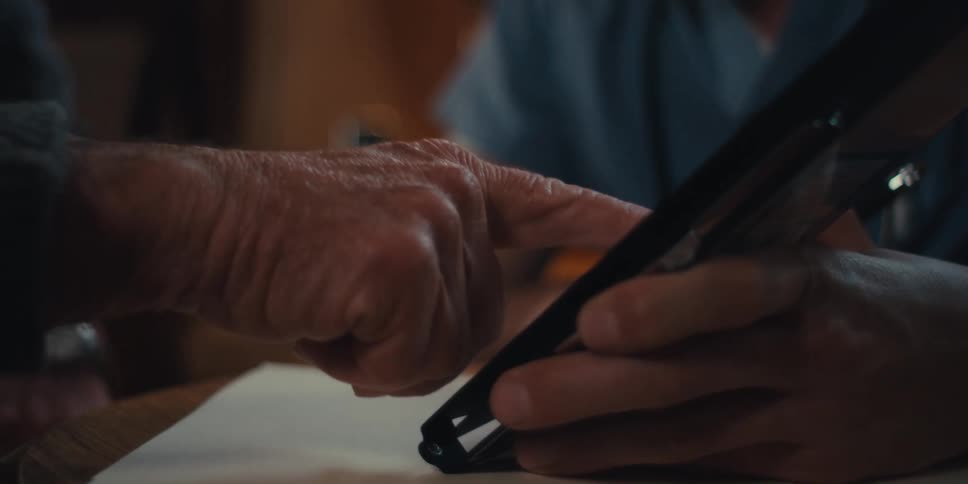 The man talks while touching the display on the tablet