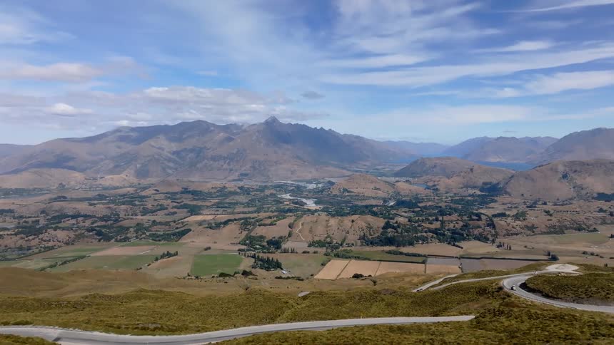 Aerial scene of a mountain valley on a day with scattered clouds