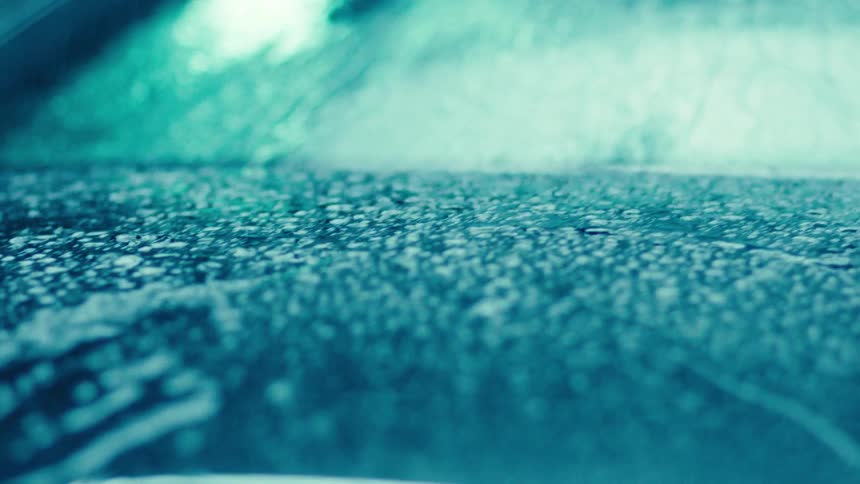 Water running down the windshield of a vehicle