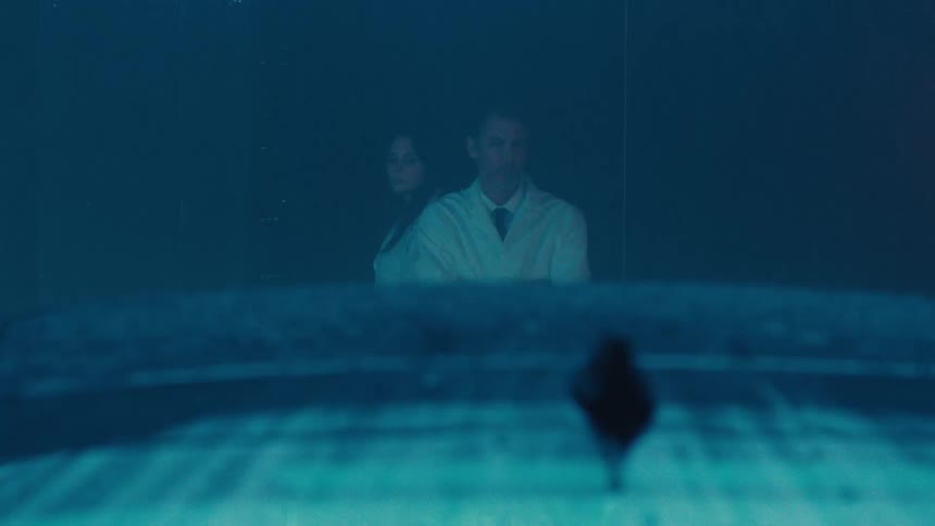 Two scientists observing a rain experiment in a car