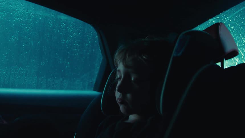 Little boy sleeping inside the car