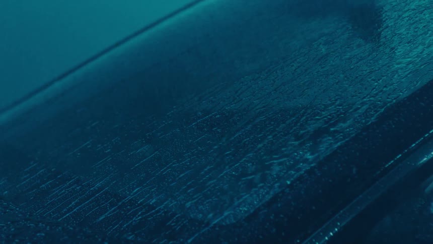 Windshield of a vehicle with rain falling