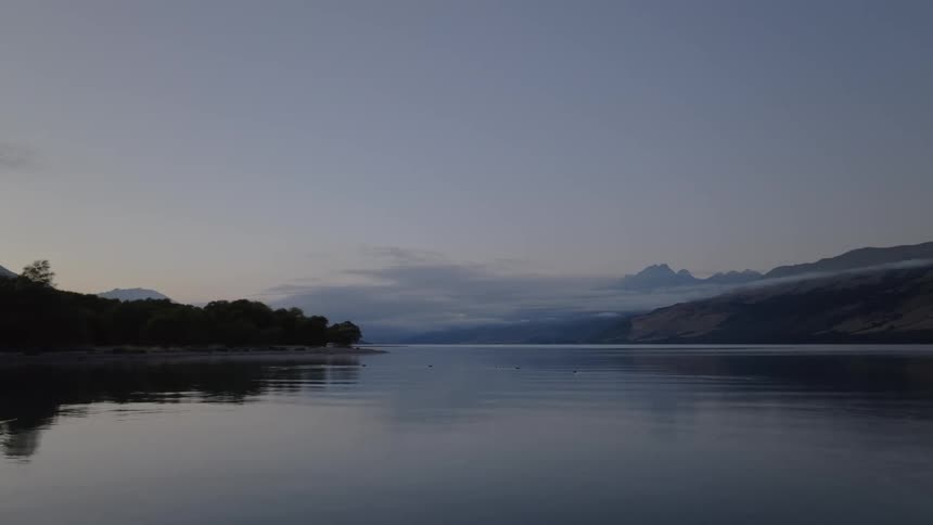 Calm lake surrounded by mountain range