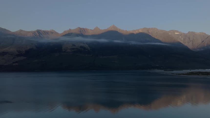 Landscape of a calm lake with mountains on the horizon
