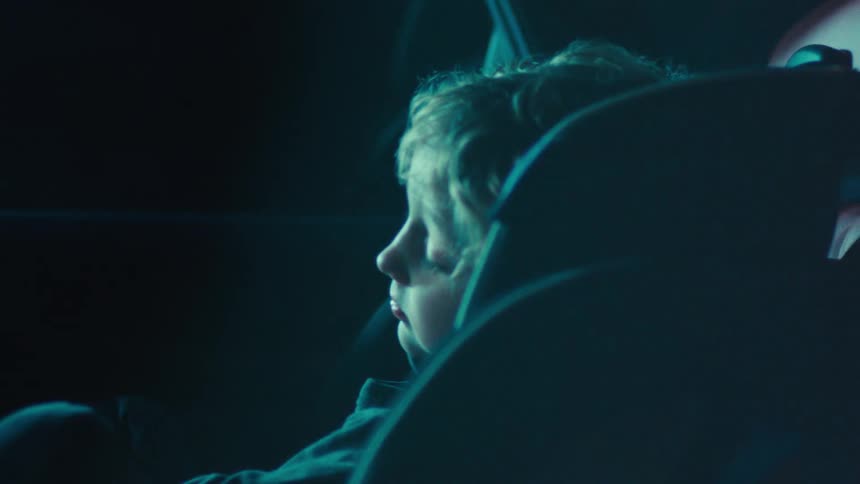 A footage of a kid sleeping in a car