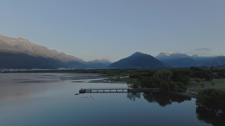 Sunrise landscape of a calm lake with mountains around