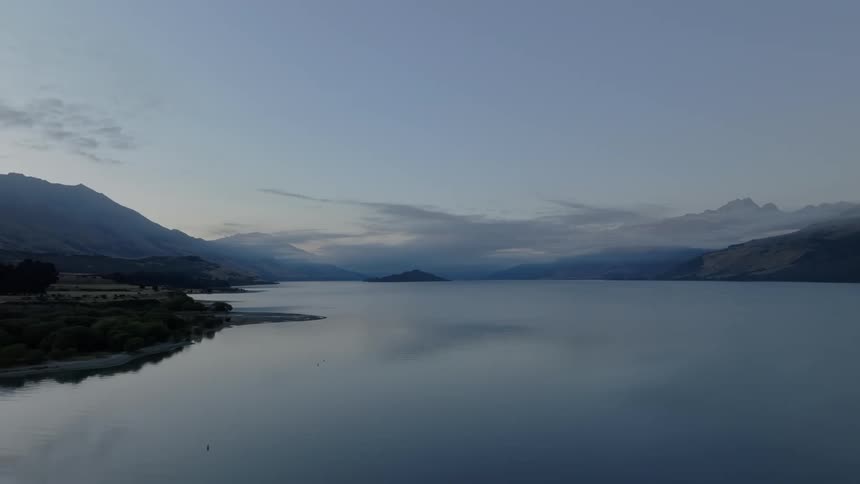 The sun is setting above the calm ocean water