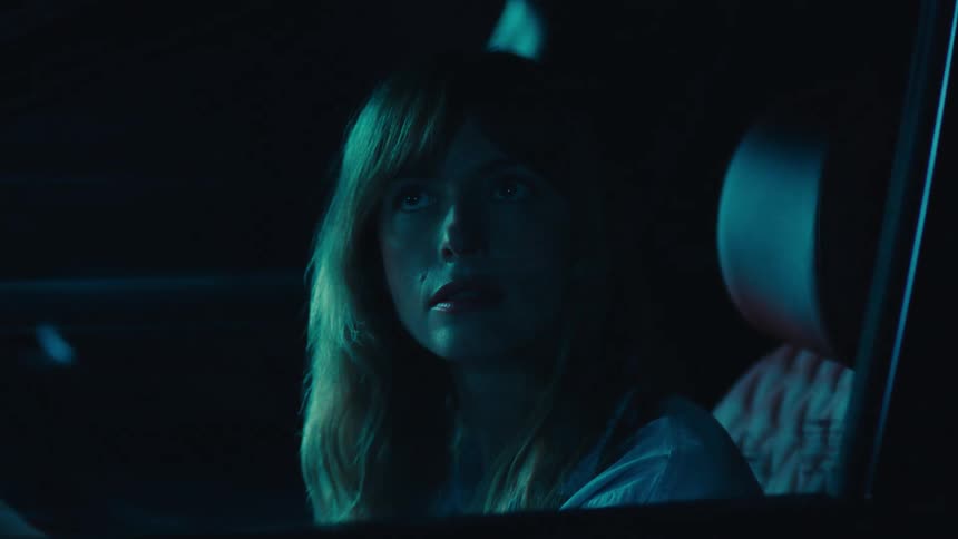 Woman looking around while driving a car