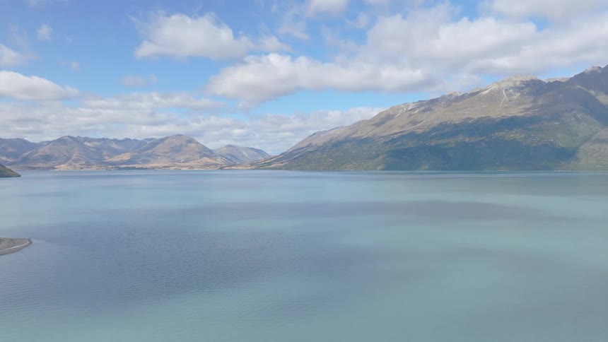 A calm blue sky over a lake in the mountains