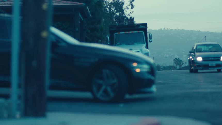 A footage of a car and truck parked at a junction