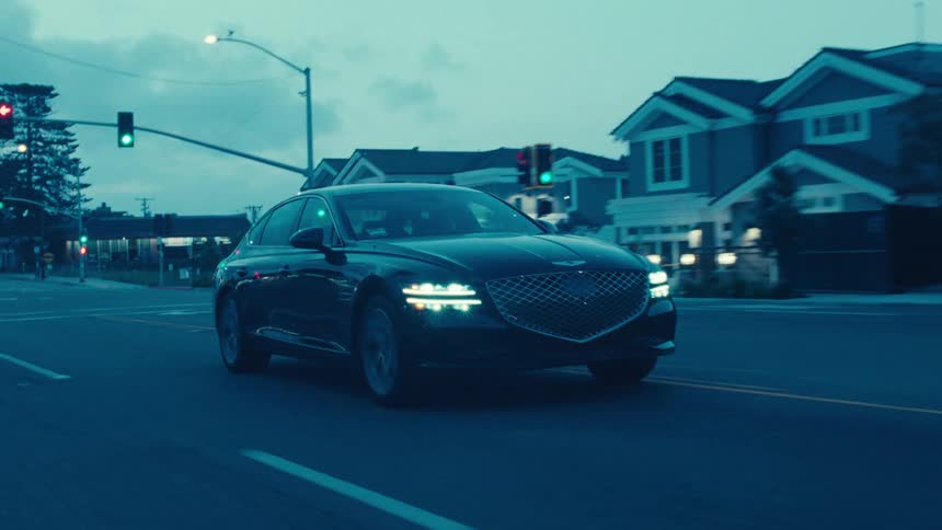 Black sedan car traveling down a road
