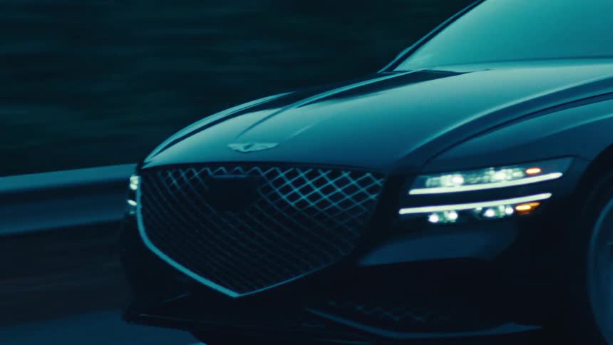 Black sedan car traveling down a road