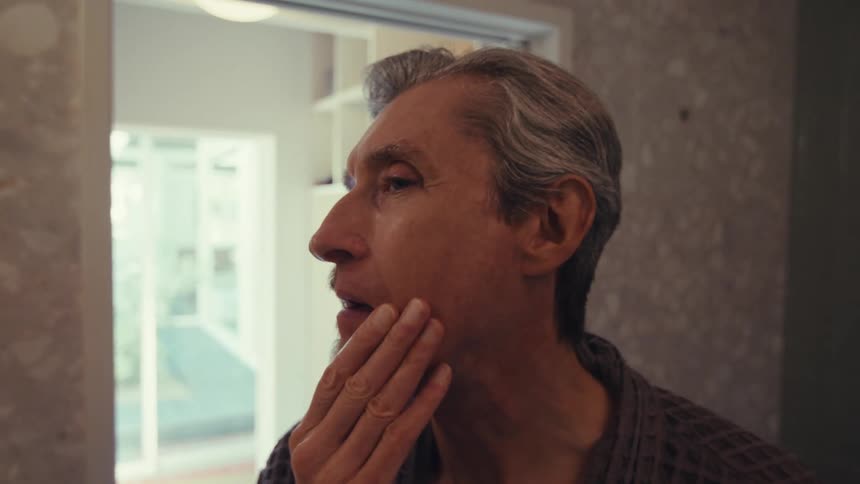 Portrait of a man shaving