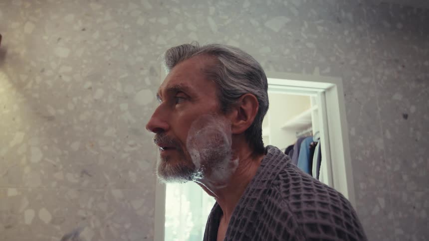 Man shaving in the bathroom