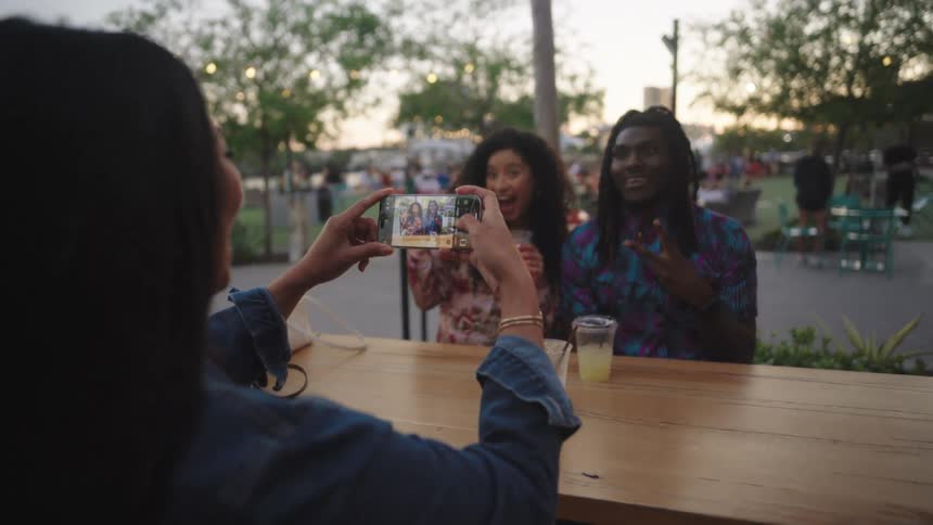 A woman takes a photo of her friends
