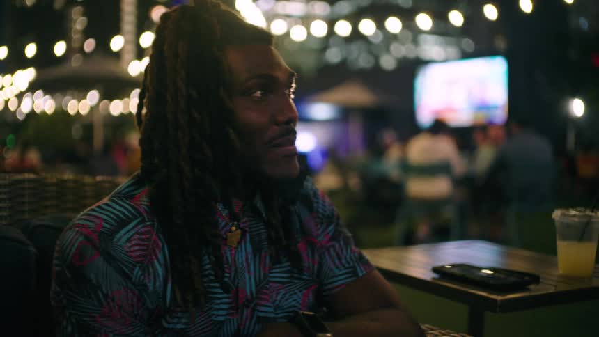 A man is talking with a drink