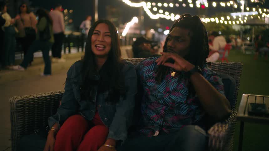 Friends chat and laugh at the outside bar