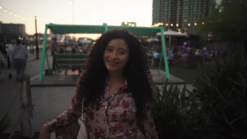A woman smiles in the city
