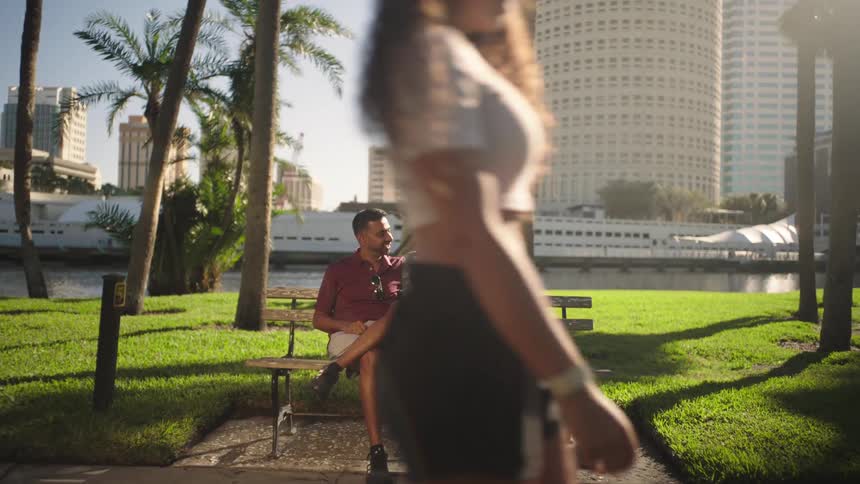 A footage of a couple sitting on a chair at a park