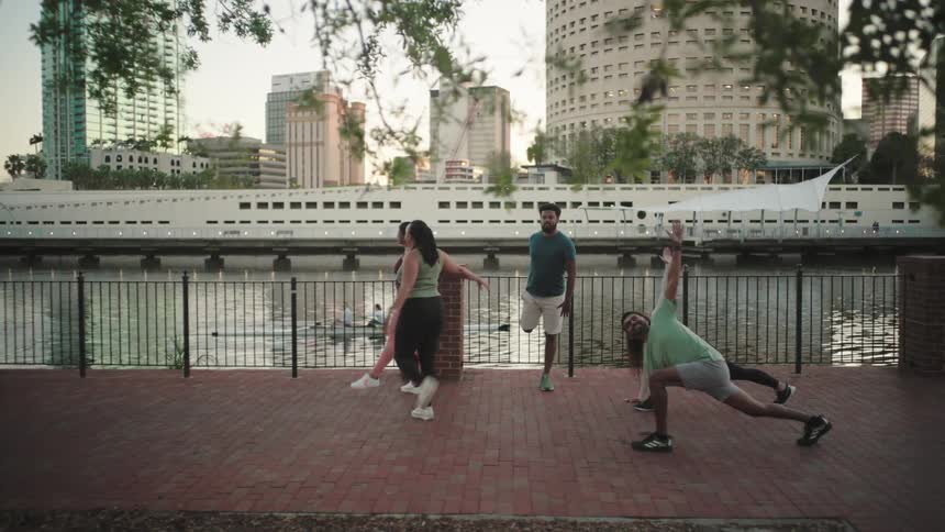 Group of people stretching on the edge of a sea canal