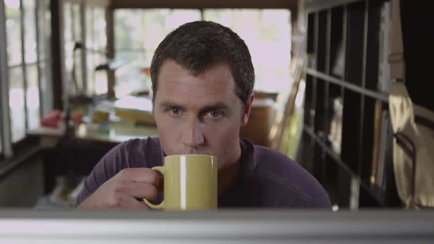 A man sips from a mug