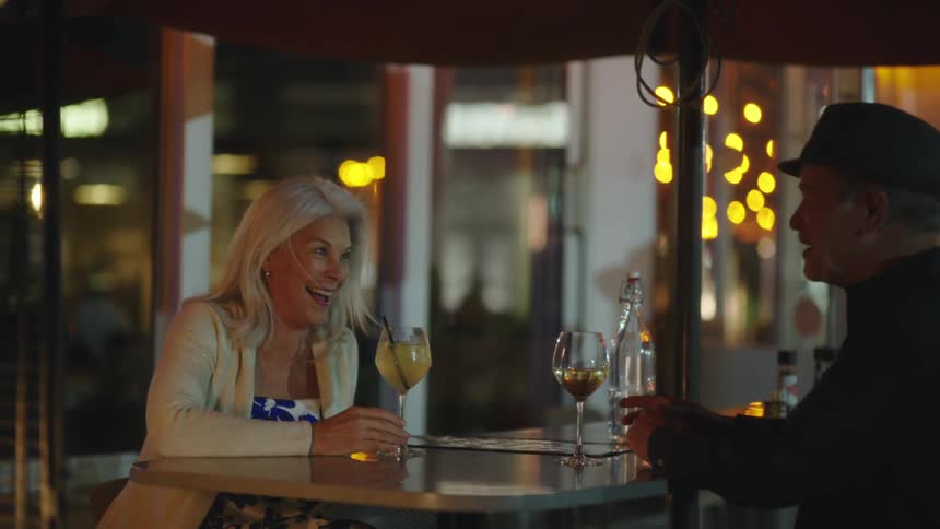 Elderly couple in a restaurant drinking wine