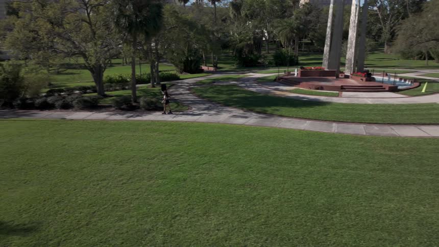 A woman is rollerblading in the park