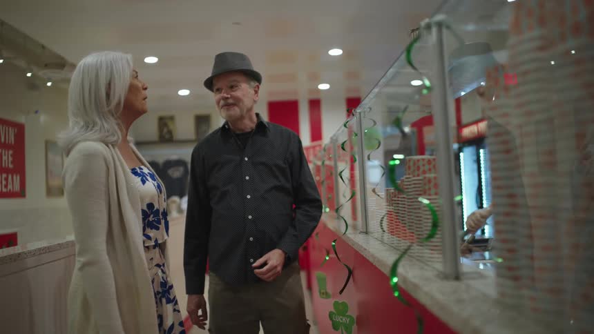 Woman and a man talking inside a food store