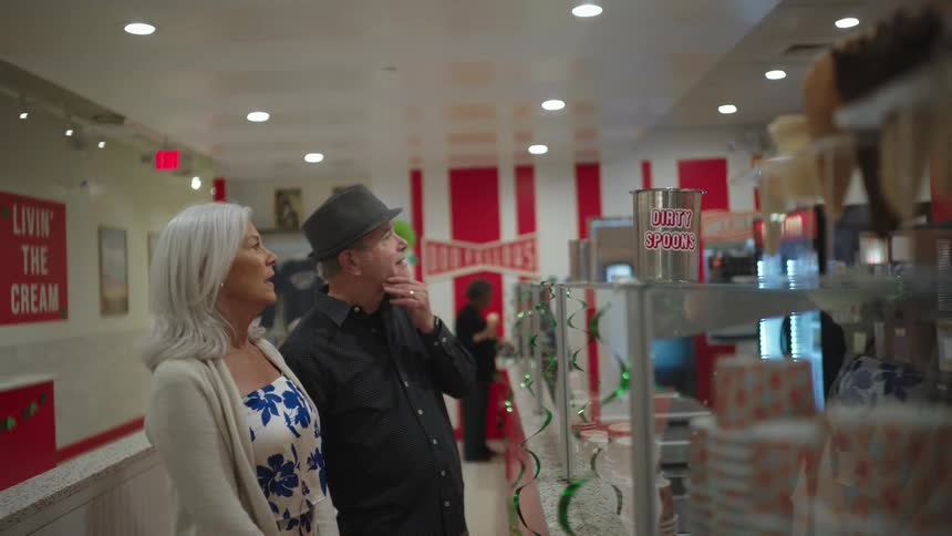 Elderly couple talking inside a restaurant