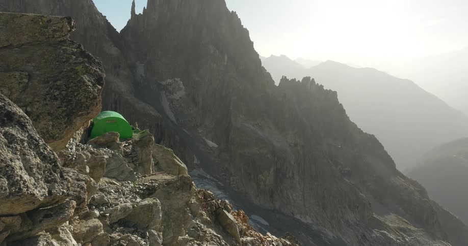 A tent is set on the mountain peak
