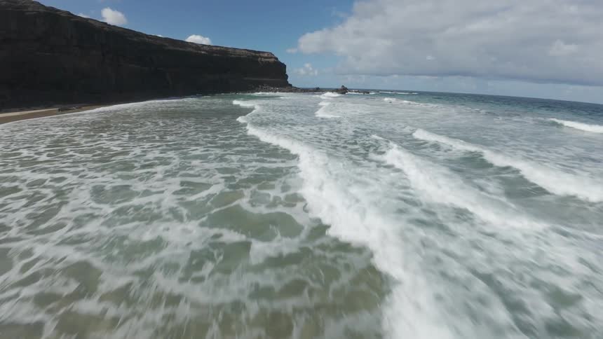 Flying over a rocky beach