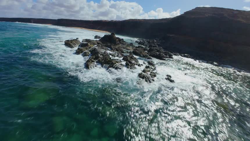 Flying over a rocky sea coast