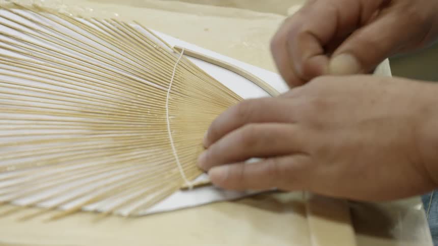 Person assembles paper fans